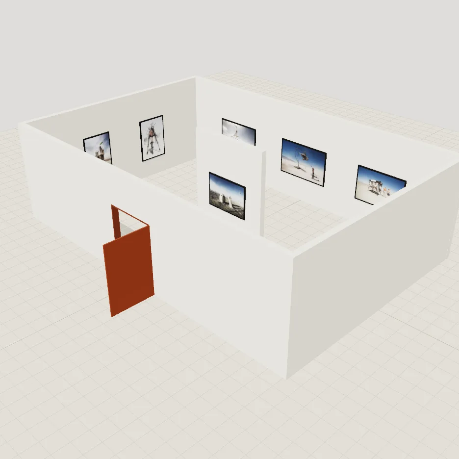 A white gallery room seen from above, Burning Man photographs hung on the walls and on a partition in the middle